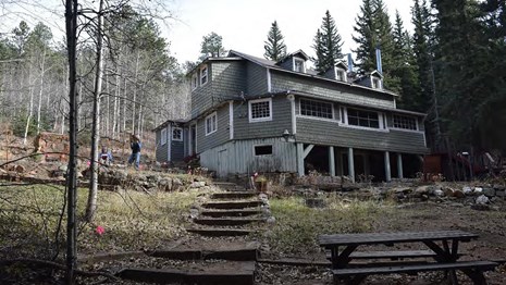 View of Winks Panorama - green one and a half story building set back on path