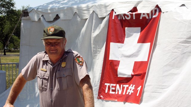 A Park Ranger staying hydrated during the event by drinking water