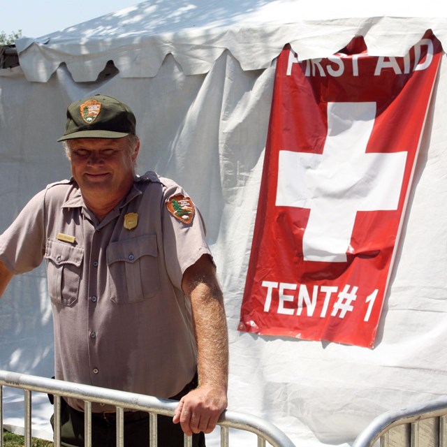 A Park Ranger staying hydrated during the event by drinking water