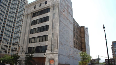 7-story concrete and steel building in cityscape