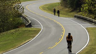 Cyclists pedal through the rolling hills of the parkway.