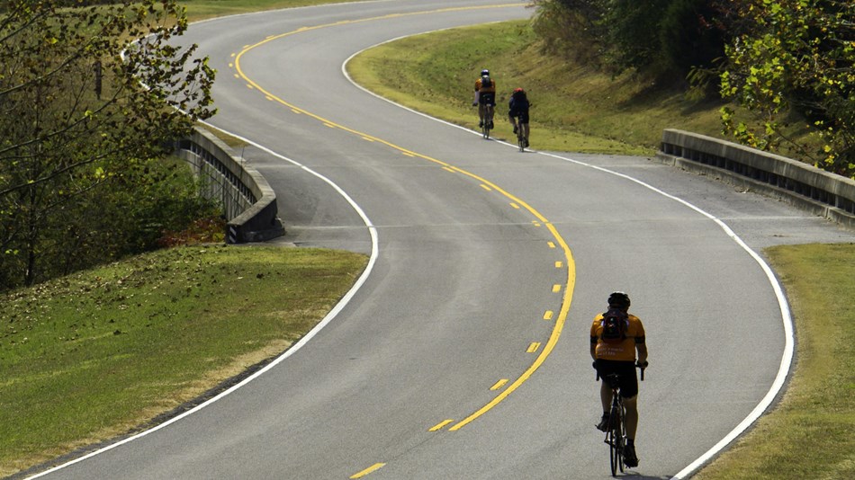 Cyclists pedal through the rolling hills of the parkway.