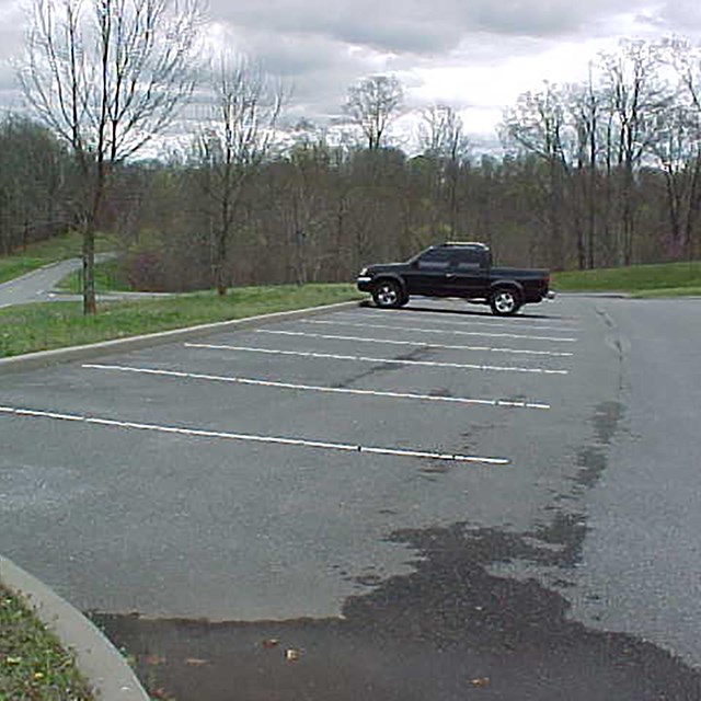 A black pickup truck in a parking lot.