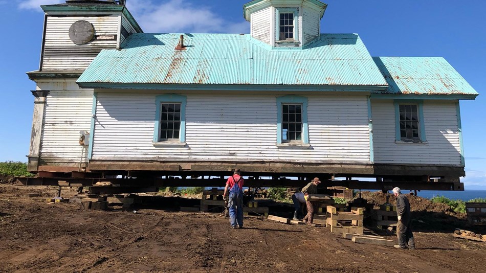 a historic building stands on the edge of a cliff