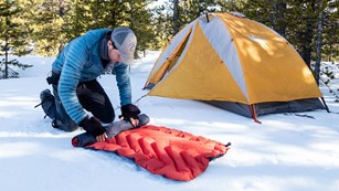 Packing up a campsite in the snow
