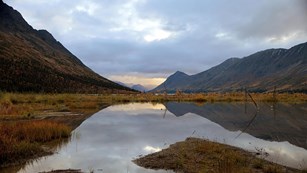 mountain lake Mountains and clouds reflect in Upper Twin Lake from near the head of the lake. Lake