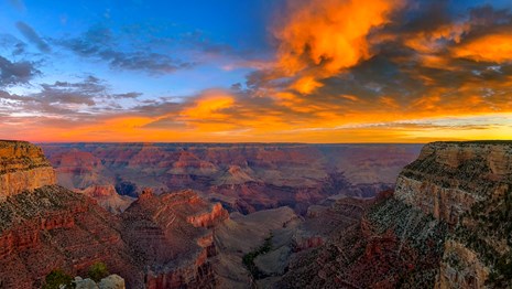 an orange sunrise over the grand canyon
