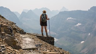 Woman hiking with mountain peaks in the distance