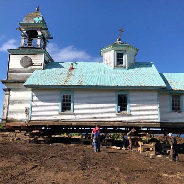 the Ascension of Our Lord Church lifted onto cribbing and beams in place in preparation for the move