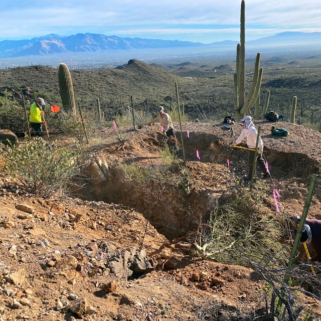 a group of people use shovels to fill in an abandoned mine