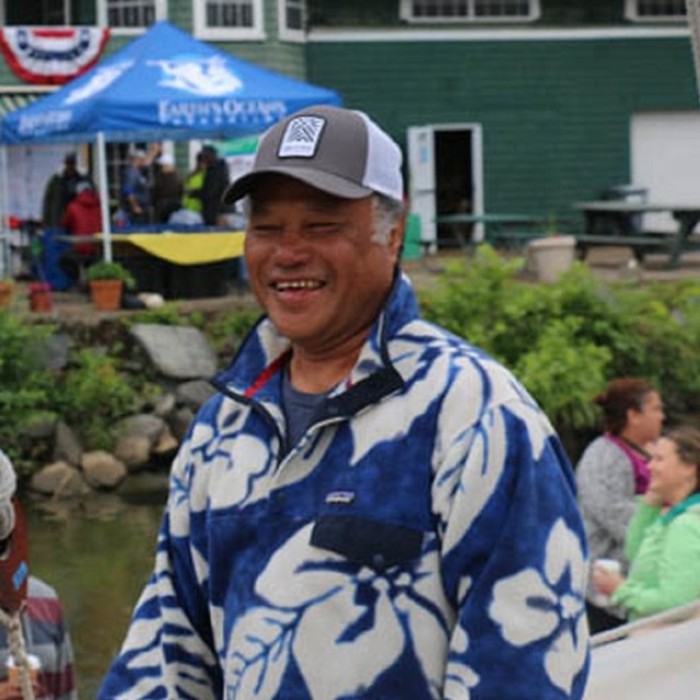 Captain Kalepa Baybayan smiles and greets guests aboard the Hōkūleʻa.