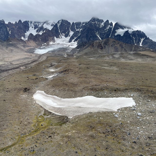 a melting snow patch on a mountainside