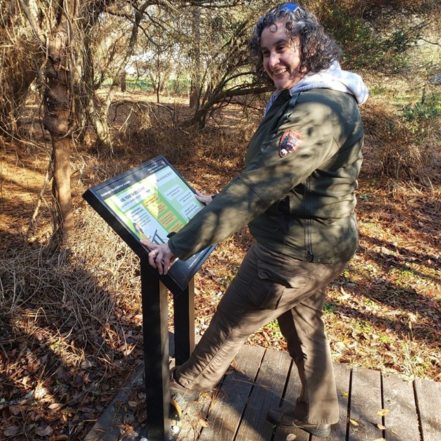an nps employee uses a boot brushing station