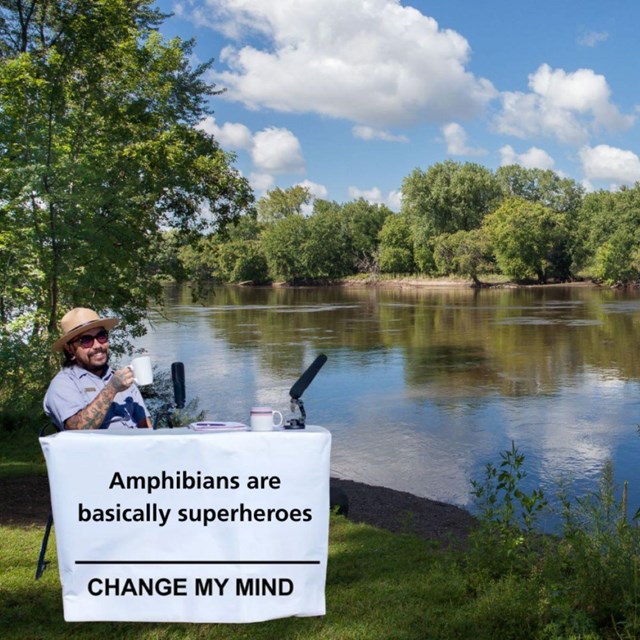 ranger at table with sign that says amphibians are basically superheroes. change my mind.