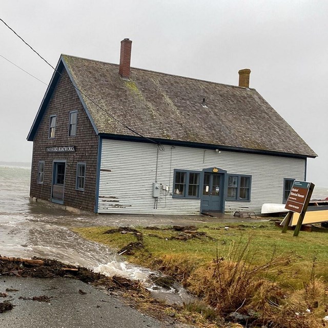 visible storm damage to a historic building on the coast