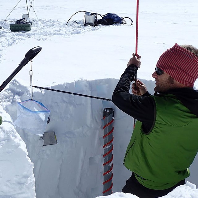 A researcher calibrates equipment