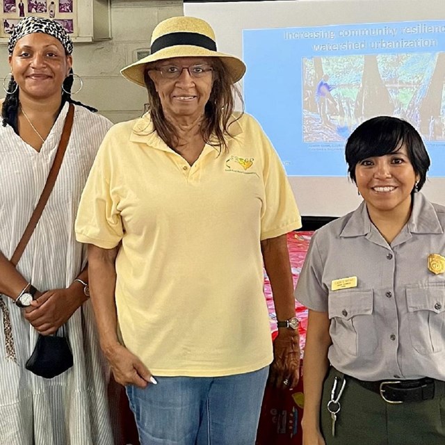 three smiling women of color