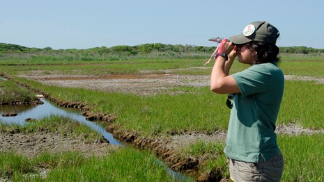 crew members assesses water salinity using a refractometer at Fire Island National Seashore