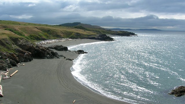 Beach view with mountains and clouds in the distance