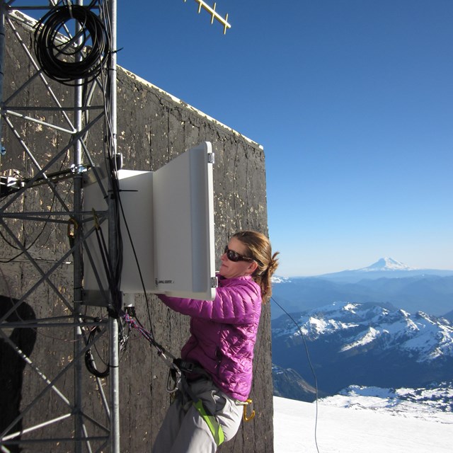 Researcher servicing weather station on Mount Rainier