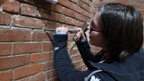 C. Cooper taking a mortar sample