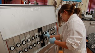Georgette Lang is rotating her samples in the QUV Weatherometer.