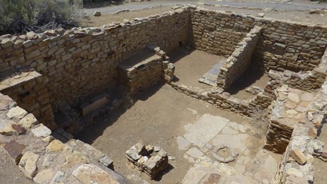 The rectangular ceremonial room inside Atsinna Pueblo showing a square wall recessed into the ground