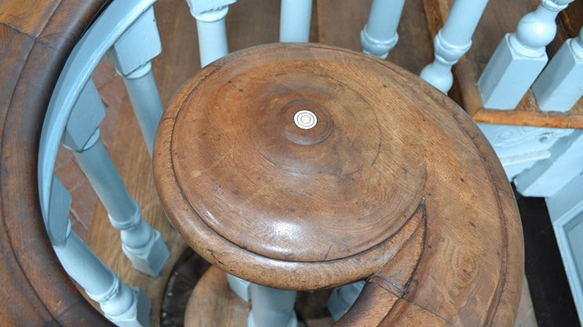Detail showing volute with inlaid ivory button on staircase inside Independence Hall.