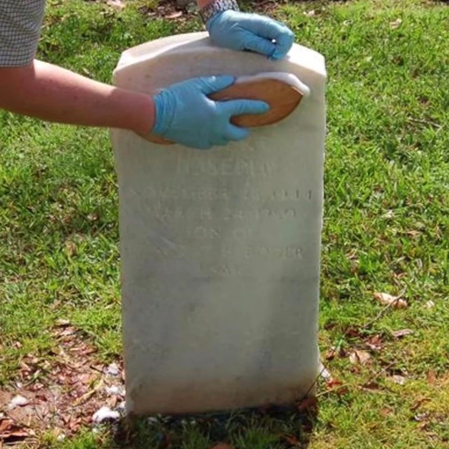 Jason Church demonstrates how to properly clean a marble gravestone.