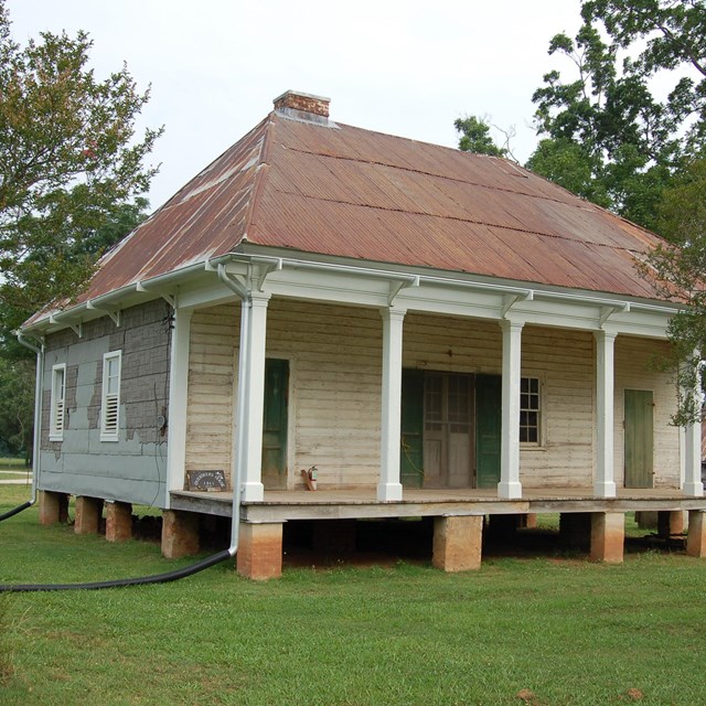 Wooden house on brick stilts