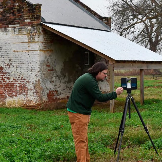 Report Cover showing Title and image of man scanning brick slave quarters