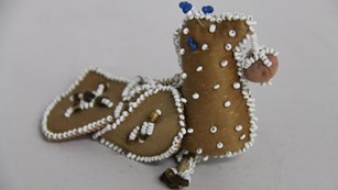 A beaded leather bird ornament.