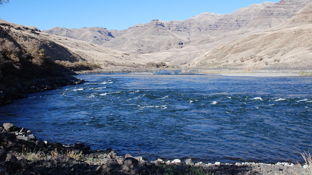 A river surrounded by rocky cliffs.