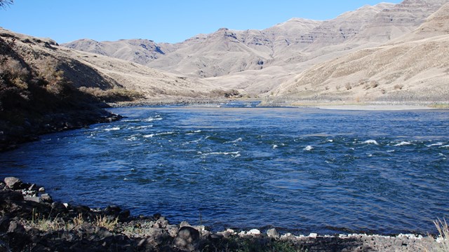 A river surrounded by rocky cliffs.