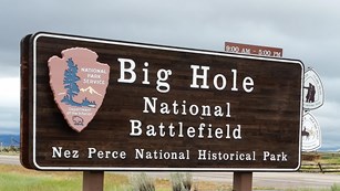 A wooden sign with the words "Big Hole National Battlefield Nez Perce National Historical Park."