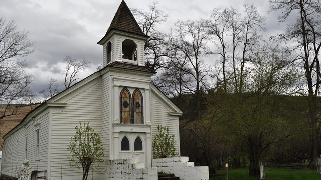 A white chapel in on a cloudy day.