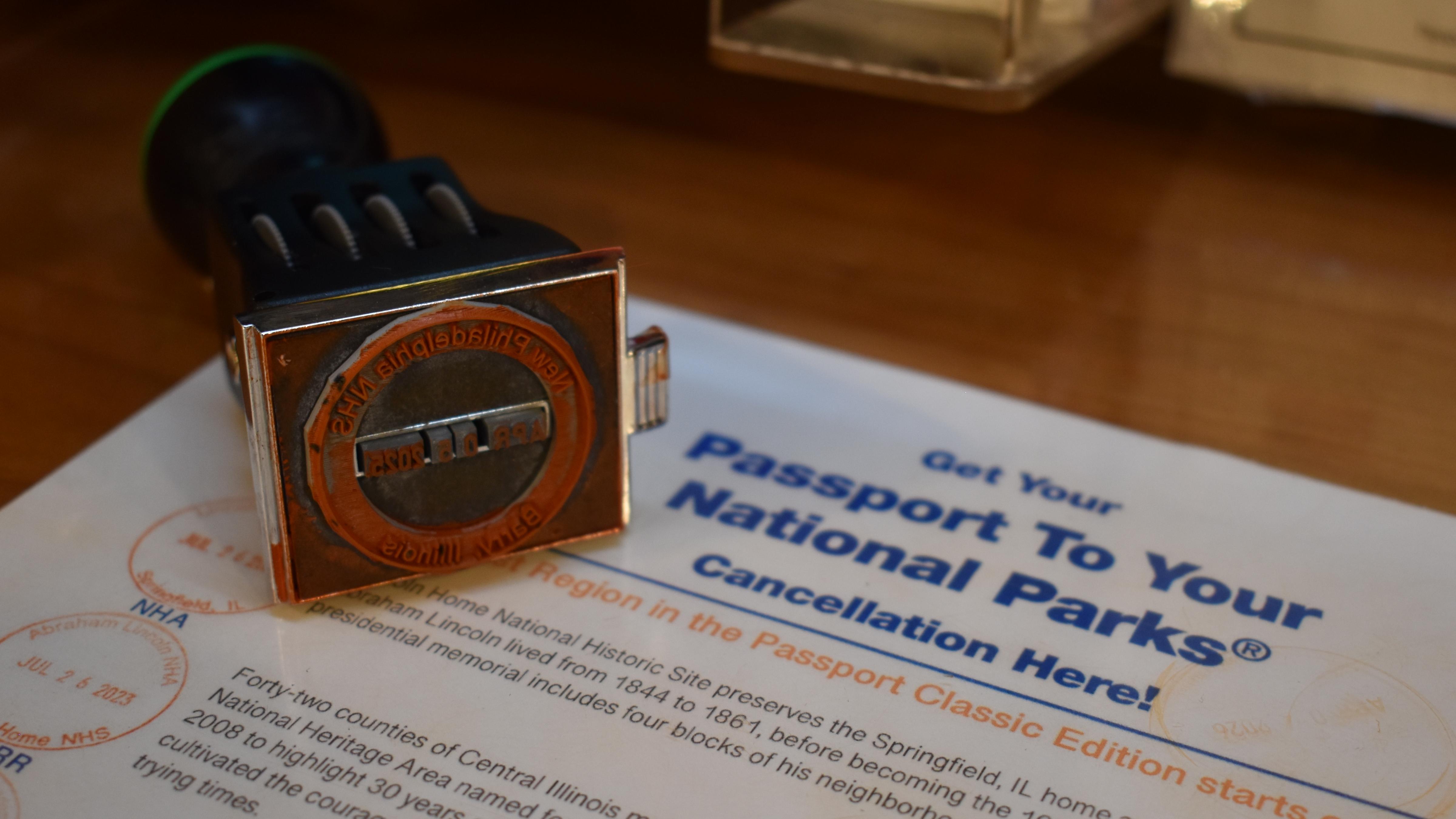 A rubber stamp labelled "New Philadelphia National Historic Site" lies on a countertop.
