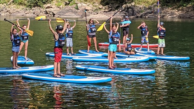 kids on paddleboards in the river