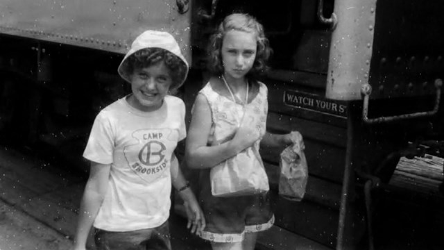 black and white photo of girls with camp shirts