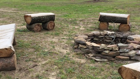 log benches around a fire pit