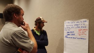 park ranger and community member looking at flip chart
