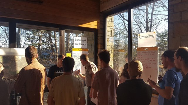 people engaged in a meeting in a park visitor center