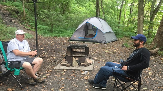 campers with tent in campsite