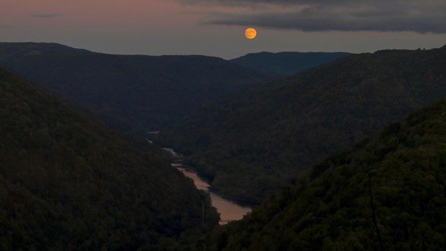 moon over a deep river gorge