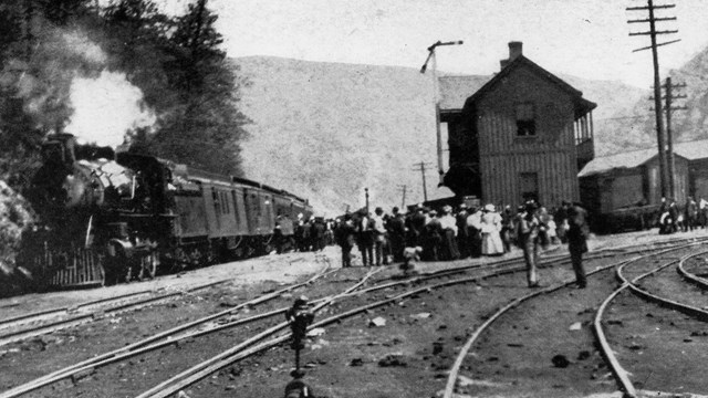 historic black and white photo of railroad depot with train