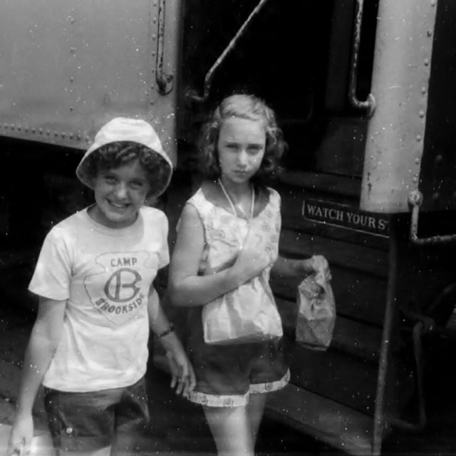 girls boarding train for summer camp