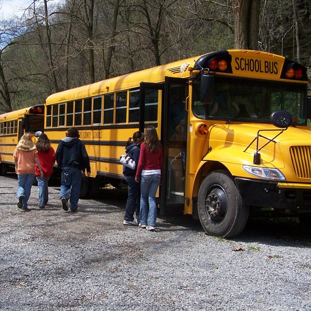 students getting off school bus