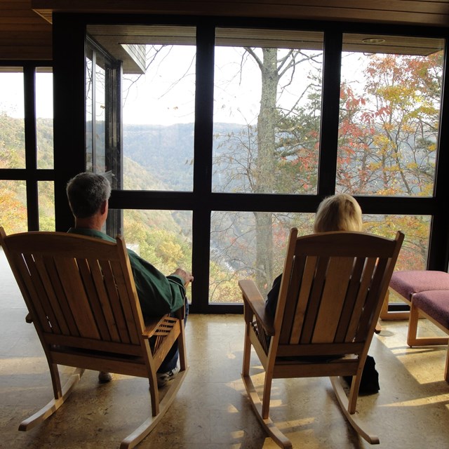 visitors in rocking chairs admire the view