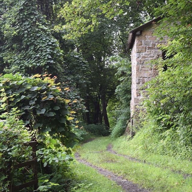 trail passing old mining building ruins