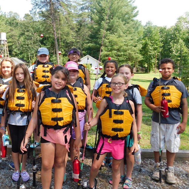 kids with life jackets preparing for a river trip